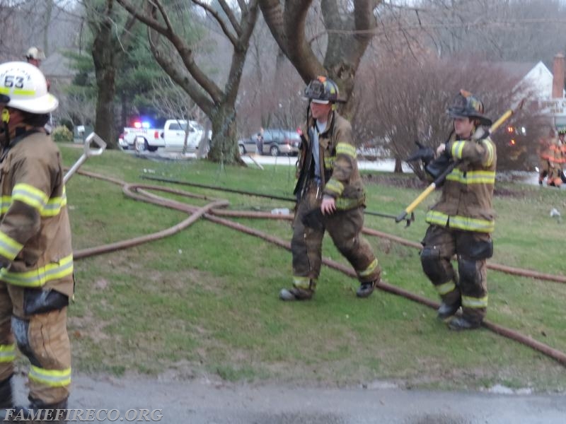 Ladder 53 crew prepares to assist with overhaul at garage fire. PHOTO BY: Travis Tiffany